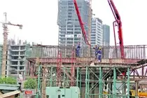 Công trường xây dựng tòa nhà cao tầng với cần cẩu và giàn giáo
