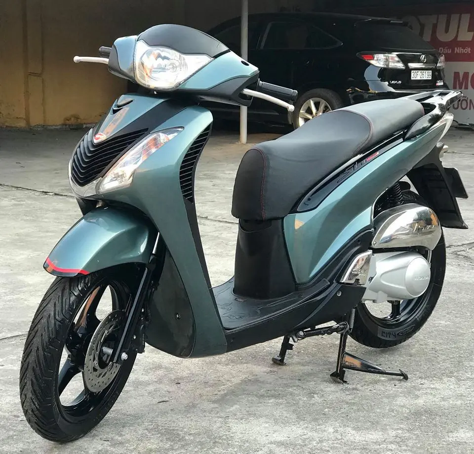 Xe Honda SH màu xanh dựng trên sân